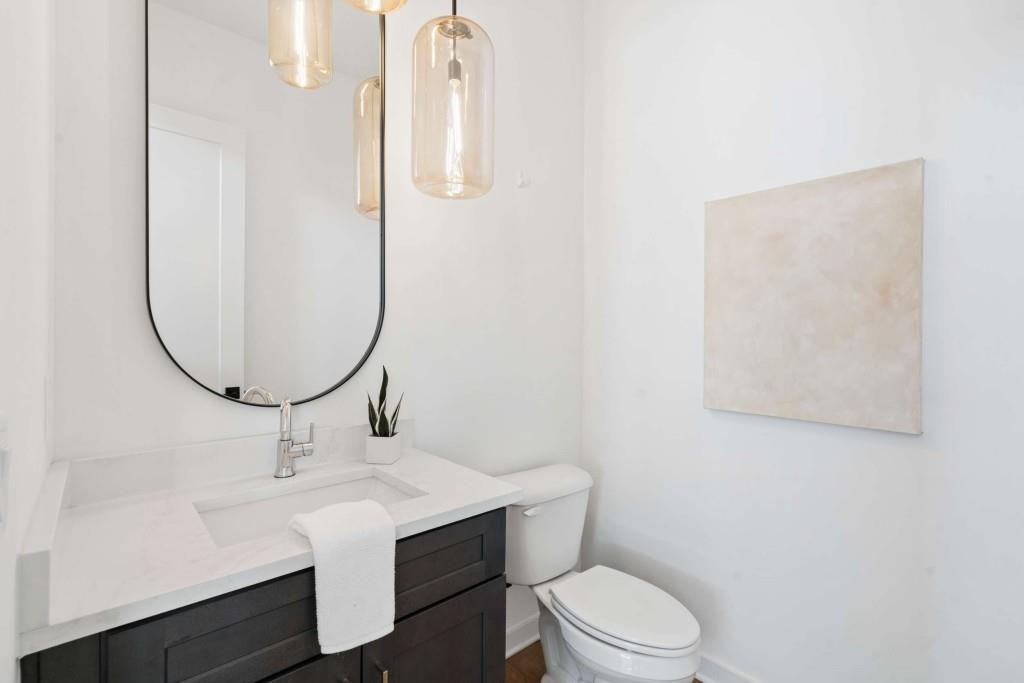 32 Walthall Street Northeast, Unit A Atlanta, GA 30307 - Photo 17 of 39 a bathroom with a sink mirror vanity and toilet
