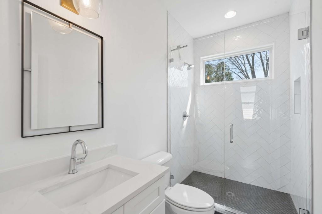 32 Walthall Street Northeast, Unit A Atlanta, GA 30307 - Photo 23 of 39 a bathroom with a sink a toilet and shower