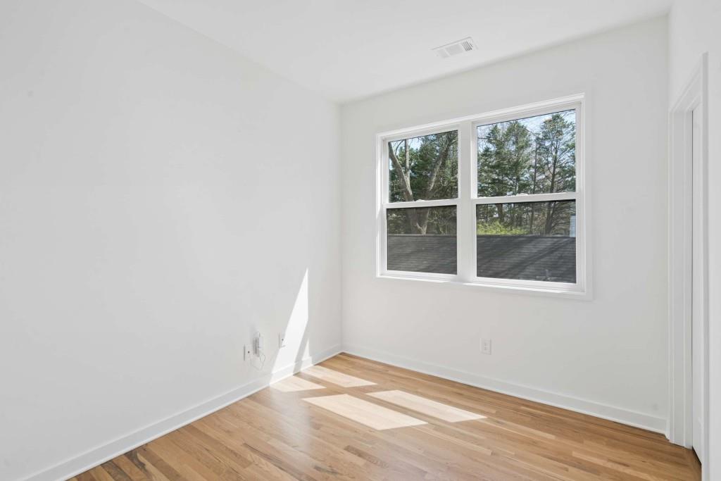 32 Walthall Street Northeast, Unit A Atlanta, GA 30307 - Photo 29 of 39 a view of an empty room with wooden floor and a window