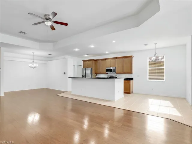 a view of kitchen with refrigerator and window