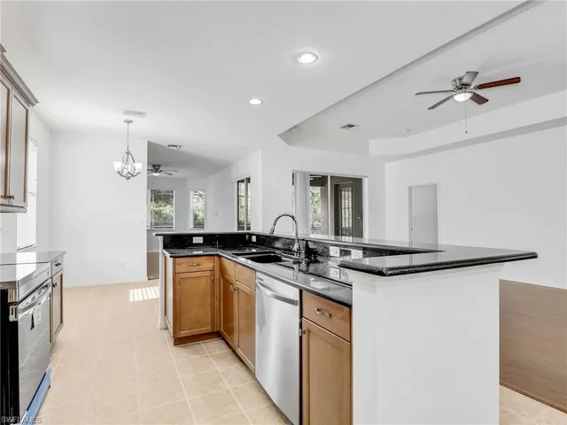 a kitchen with stainless steel appliances granite countertop a sink stove and cabinets