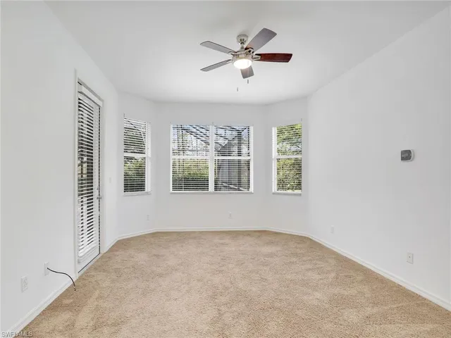 a view of a livingroom with a ceiling fan and window