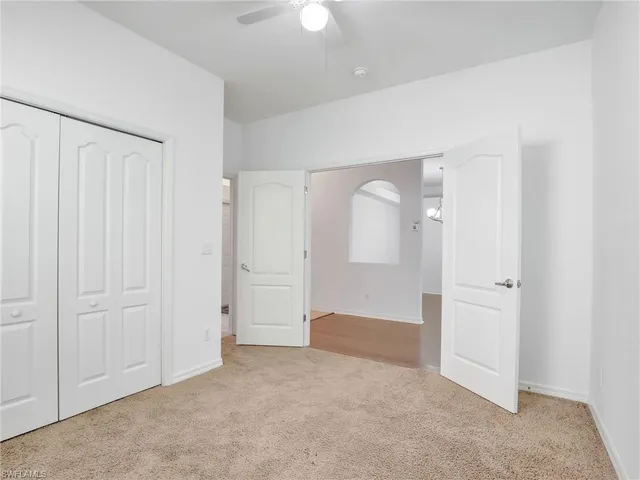 an empty room with windows and closet