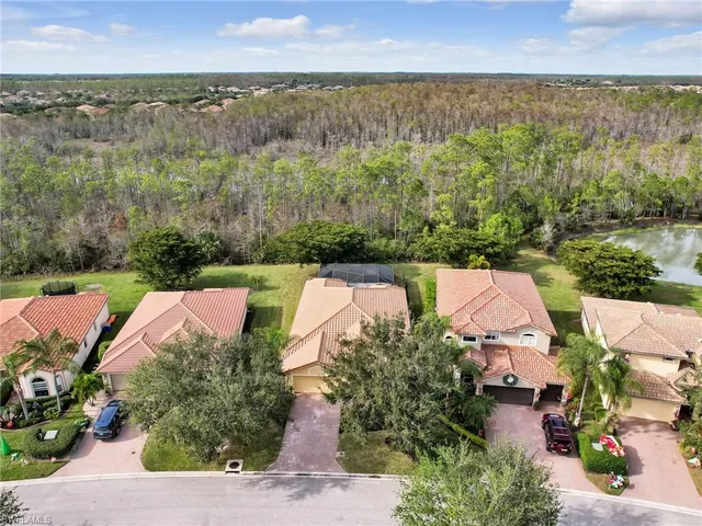 an aerial view of a house with a garden and lake view