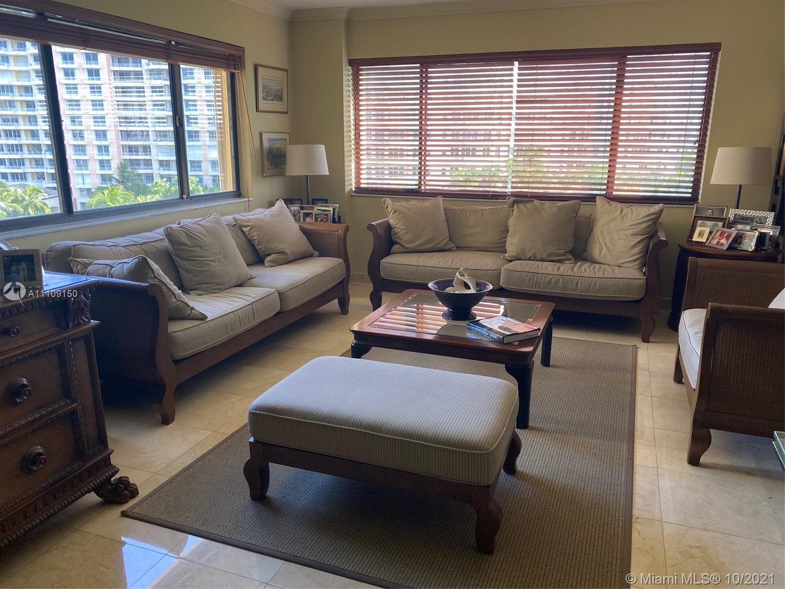 650 Ocean Drive, Unit 9E Key Biscayne, FL 33149 - Photo 2 of 5 a living room with furniture and a large window