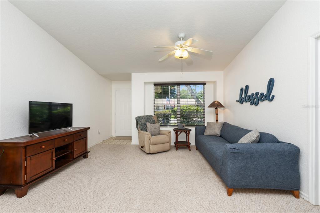 8038 Southwest 108th Loop Ocala, FL 34481 - Photo 4 of 48 a living room with furniture and a flat screen tv