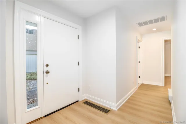 a view of a room with wooden floor