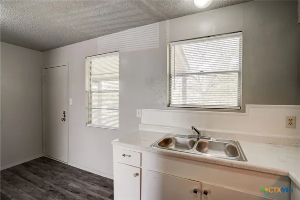 a bathroom with a sink and a window