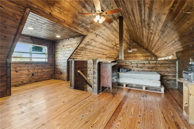 a view of a balcony with wooden floor and fence
