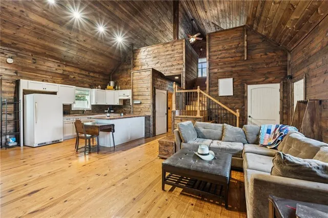 a living room with furniture tv and a fireplace