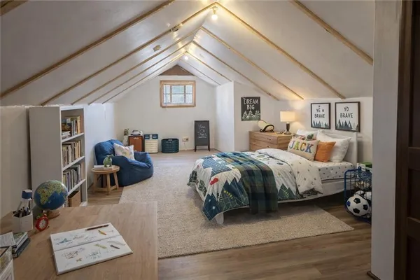 a bedroom with a bed a table and chair