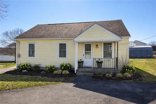a view of a house with a small yard and plants