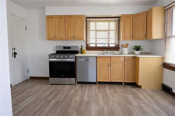 a kitchen with stainless steel appliances granite countertop a stove a sink dishwasher and a refrigerator