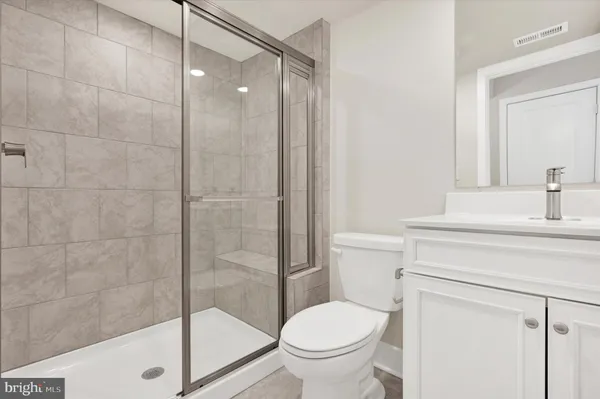 a bathroom with a shower a toilet and a sink