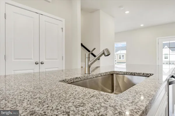 a bathroom with a granite countertop sink a mirror and bathtub