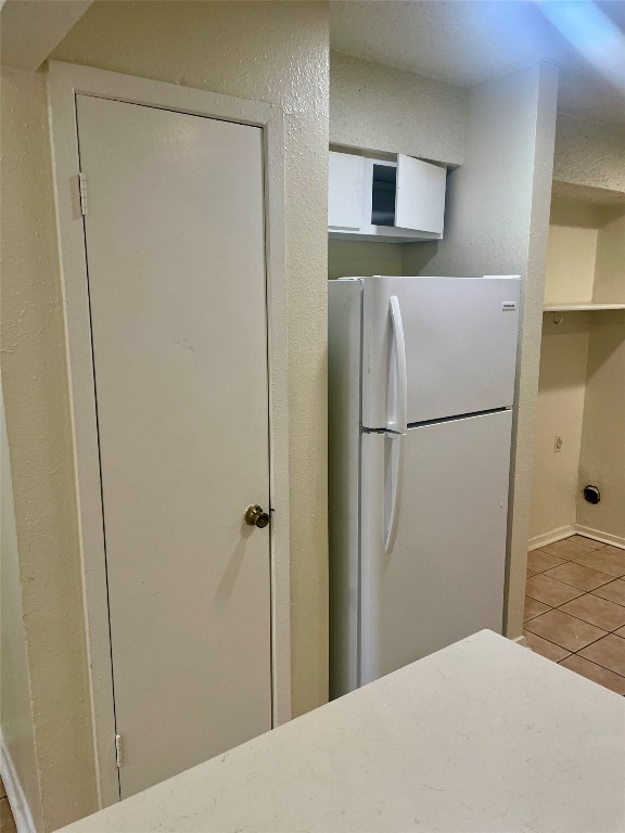 a bedroom with a bed and a refrigerator