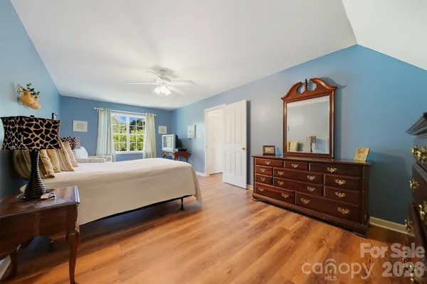 a bedroom with a bed and a mirror