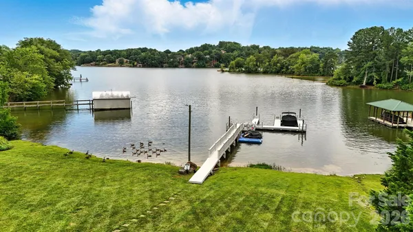 a view of a lake with a yard and mountain view