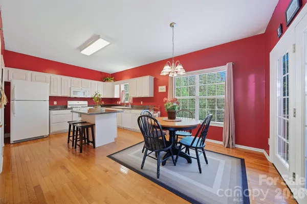 a dining room with furniture and wooden floor
