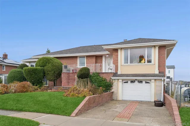 a view of a house with a yard and potted plants