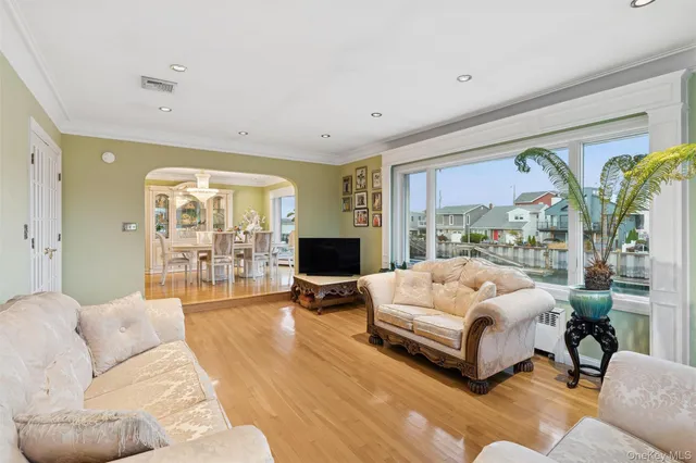 a bedroom with a large bed couch and a large window