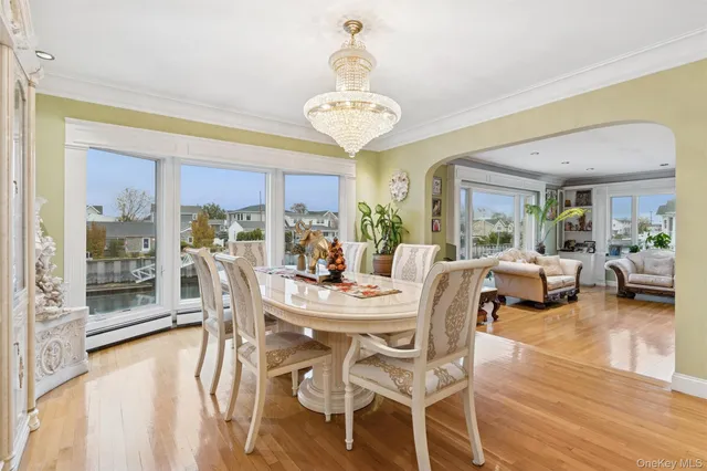 a view of a dining room with furniture wooden floor and chandelier