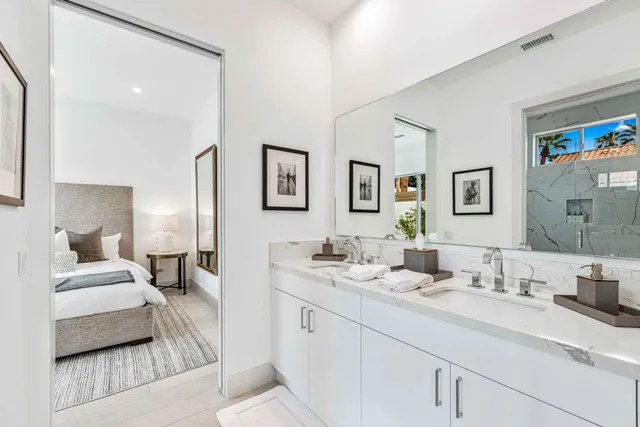 a en suite bathroom with double sink and a mirror