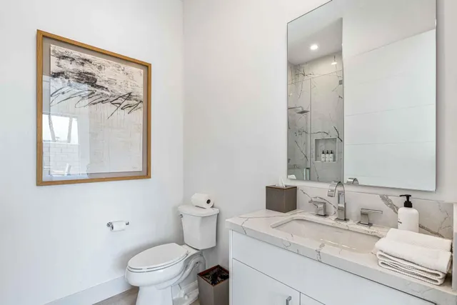 a bathroom with a toilet sink and mirror
