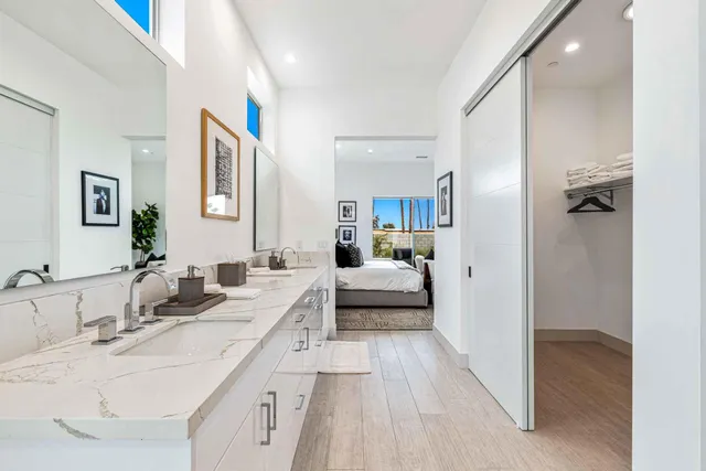 a en suite bathroom with a double vanity sink and mirror