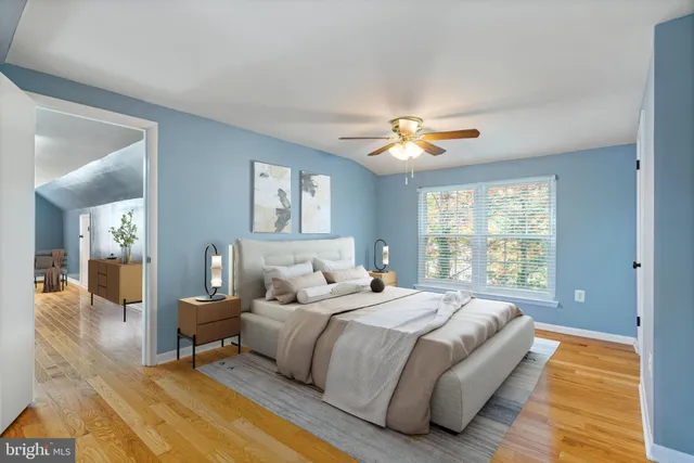 a spacious bedroom with a bed and a chandelier