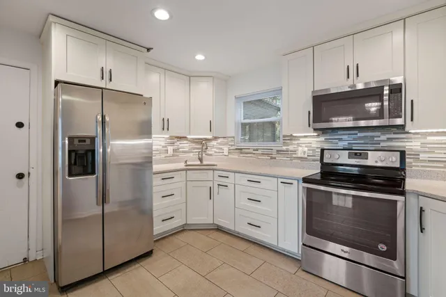 a kitchen with cabinets stainless steel appliances and a counter top space