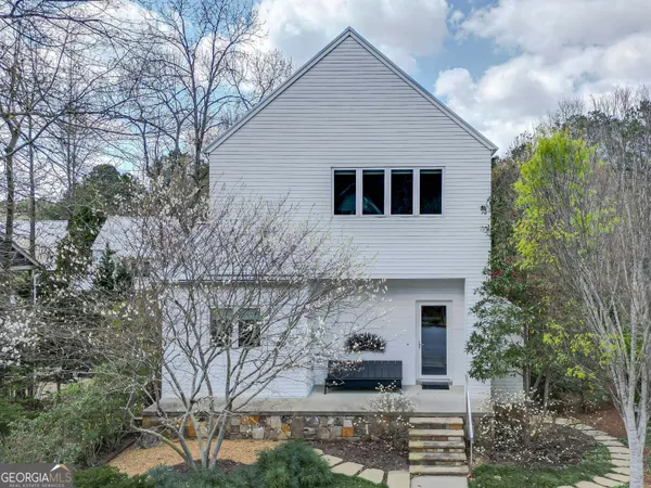 a front view of a house with trees