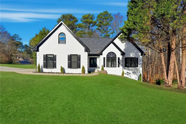 a front view of a house with a garden and porch