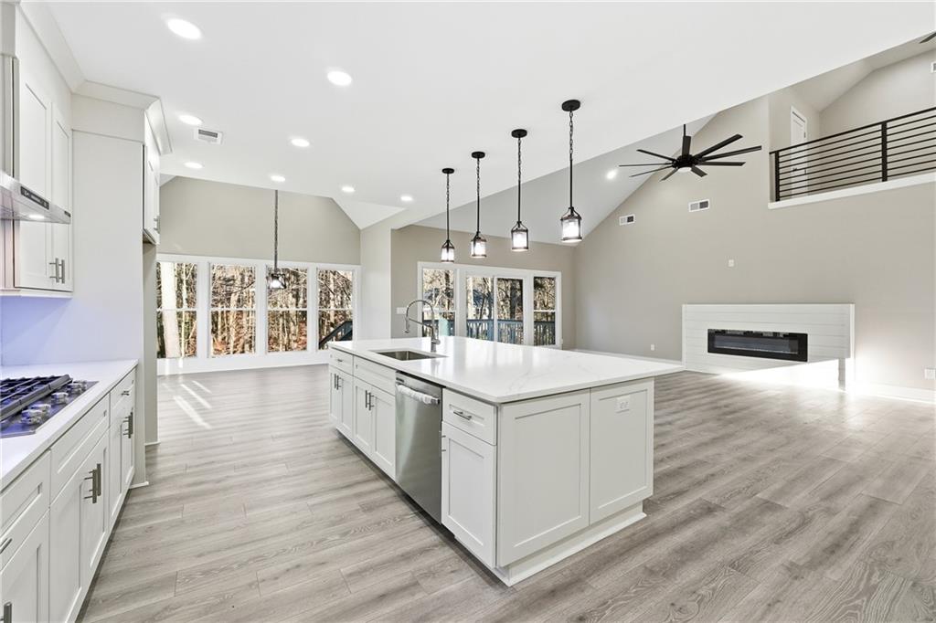 2152 Paces Vale Place Lawrenceville, GA 30043 - Photo 14 of 39 a large kitchen with stainless steel appliances granite countertop a stove and a wooden floors