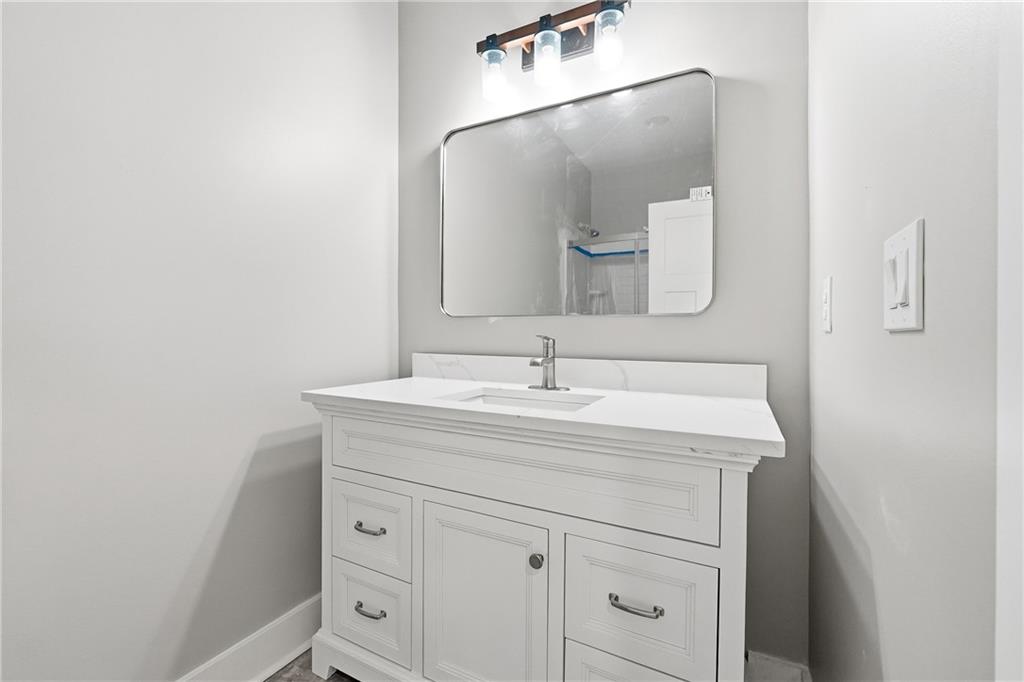 2152 Paces Vale Place Lawrenceville, GA 30043 - Photo 16 of 39 a bathroom with a sink and a mirror