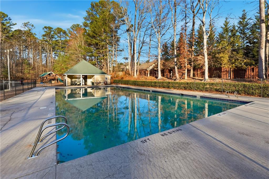 2152 Paces Vale Place Lawrenceville, GA 30043 - Photo 28 of 39 a view of a swimming pool with a patio