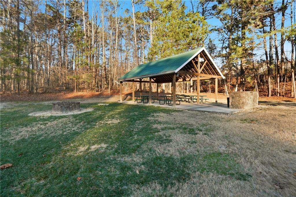 2152 Paces Vale Place Lawrenceville, GA 30043 - Photo 34 of 39 a front view of a house with a yard and trees