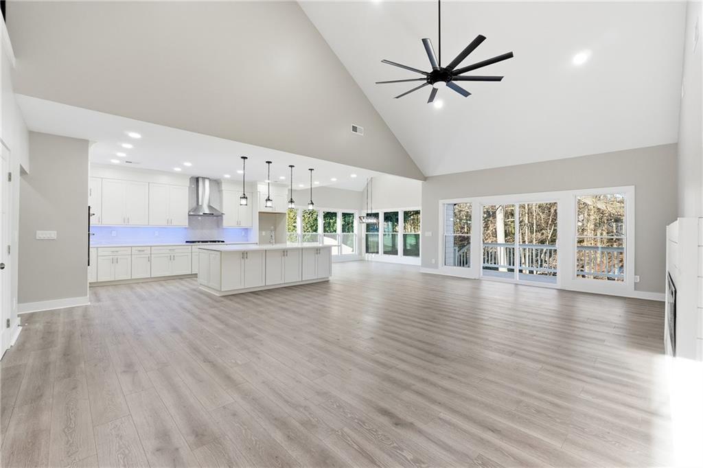 2152 Paces Vale Place Lawrenceville, GA 30043 - Photo 4 of 39 a view of a livingroom with a ceiling fan furniture a ceiling fan and wooden floor