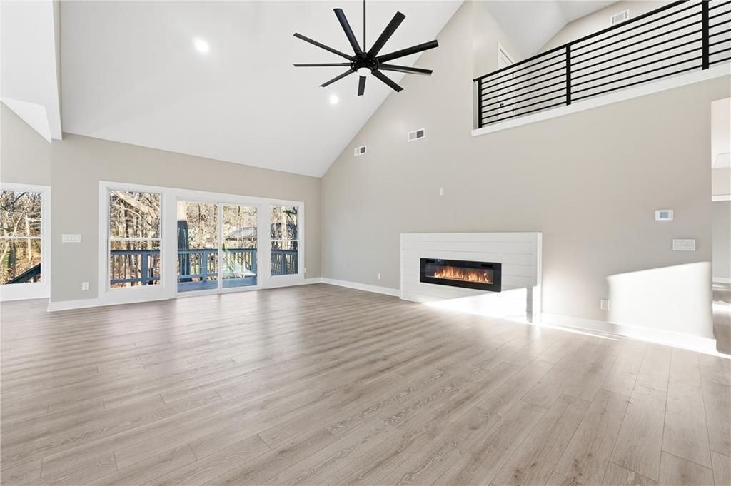 2152 Paces Vale Place Lawrenceville, GA 30043 - Photo 5 of 39 wooden floor in an empty room with a window