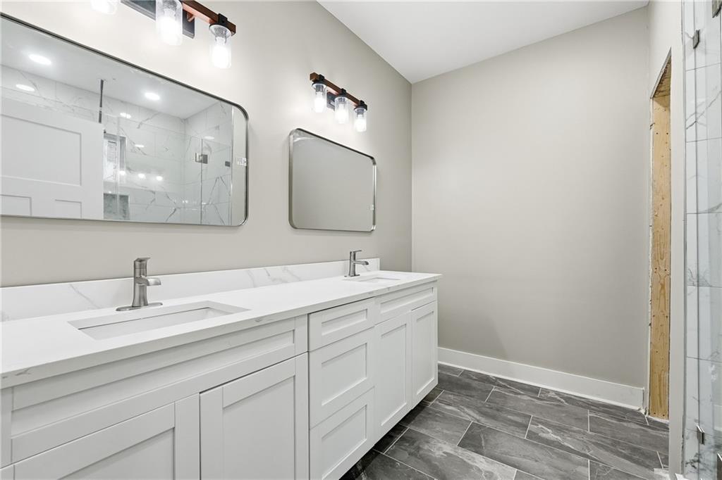 2152 Paces Vale Place Lawrenceville, GA 30043 - Photo 6 of 39 a bathroom with a double vanity sink mirror and
