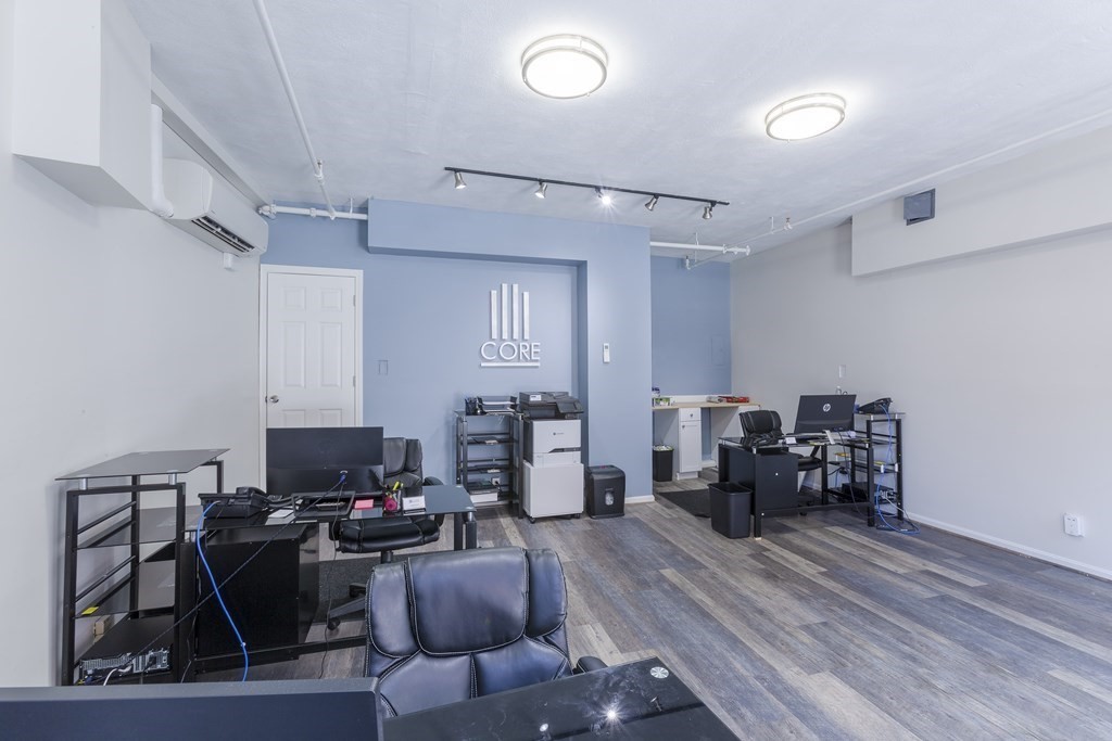 278 North Street, Unit 1 Boston, MA 02113 - Photo 4 of 5 a work room with furniture and wooden floor