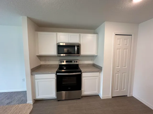 a kitchen with a stove and a microwave