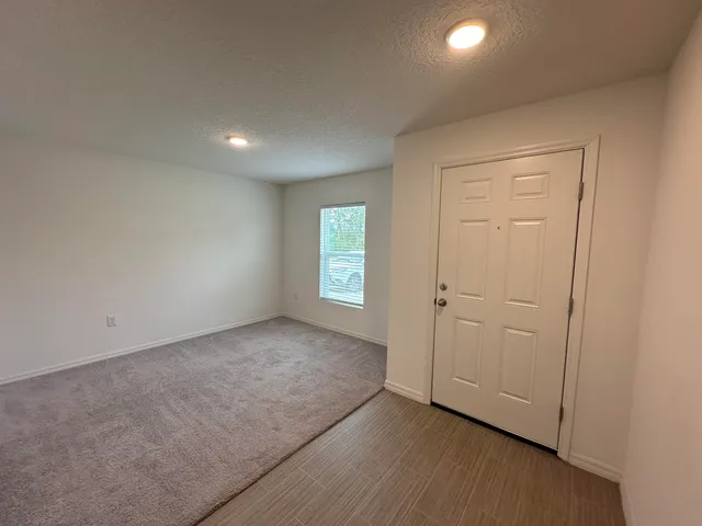 an empty room with windows and closet