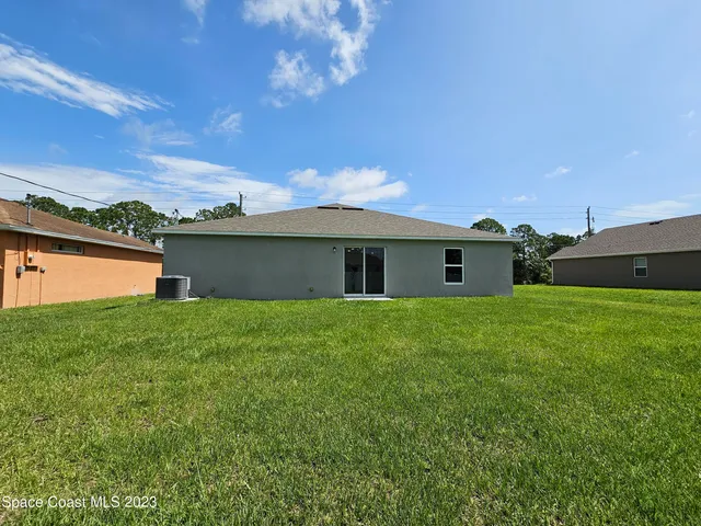 a front view of house with yard and lake view