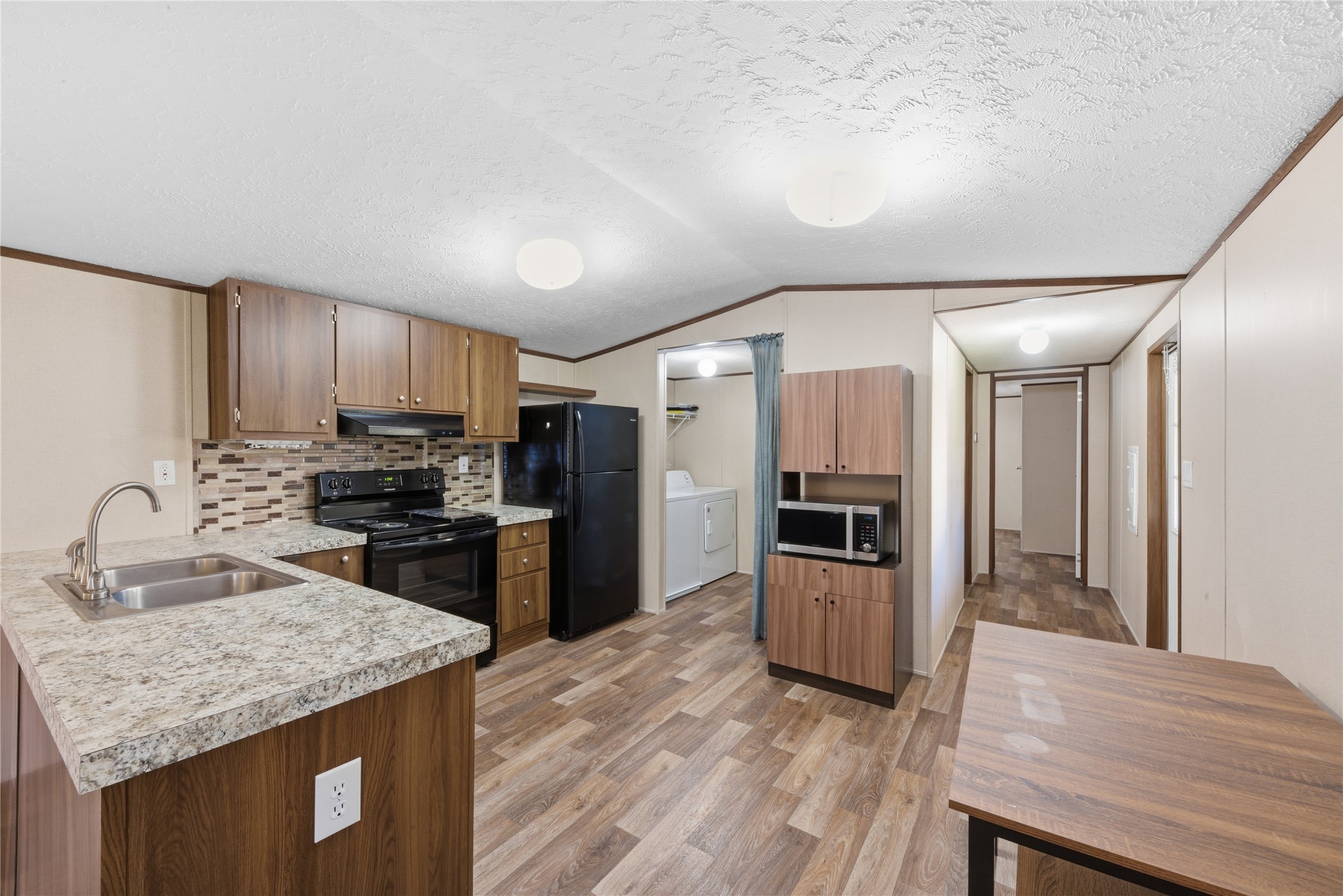 100 St Croix Drive Point Blank, TX 77364 - Photo 2 of 28 a kitchen with refrigerator cabinets and wooden floor