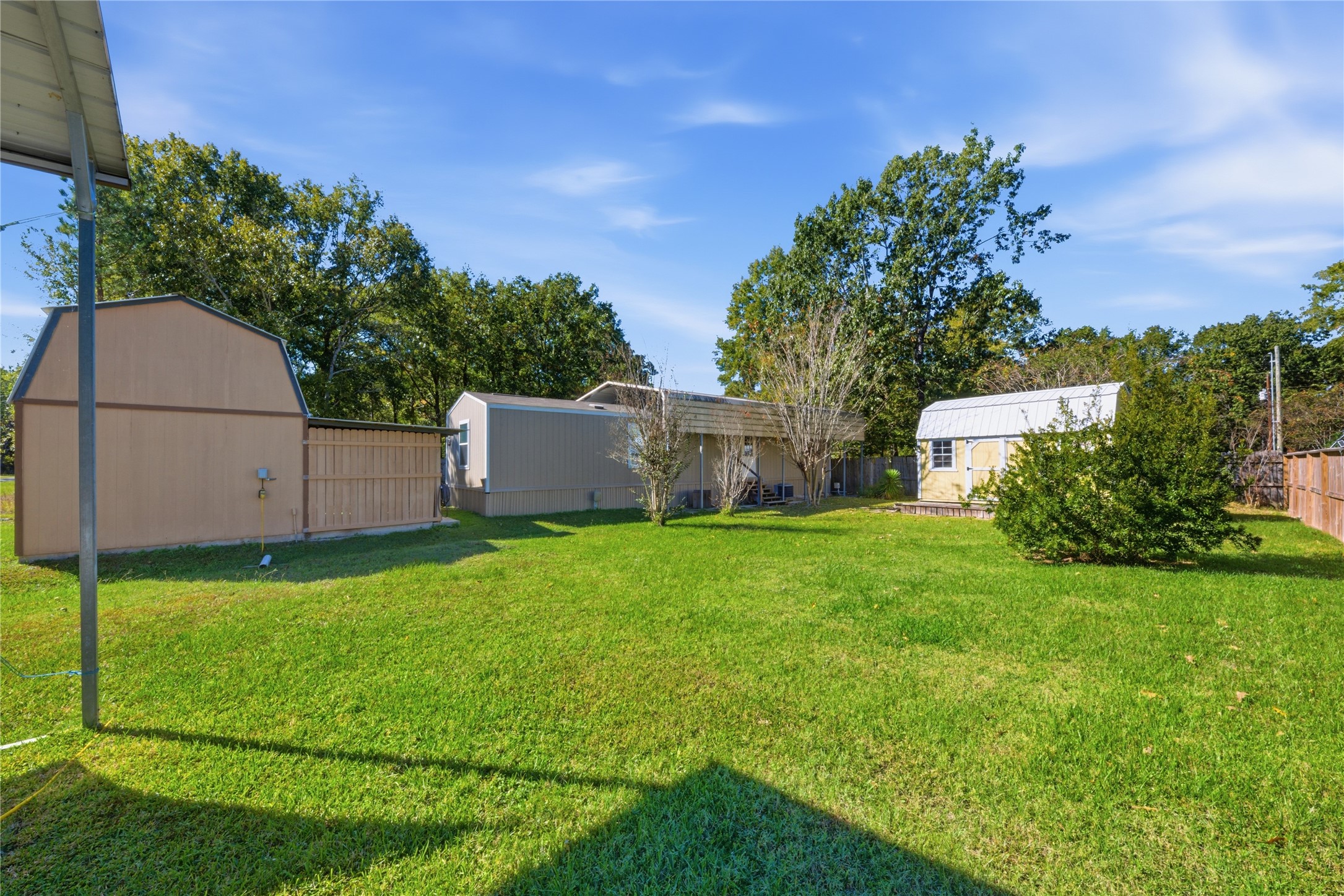 100 St Croix Drive Point Blank, TX 77364 - Photo 23 of 28 a view of a backyard with potted plants and large trees