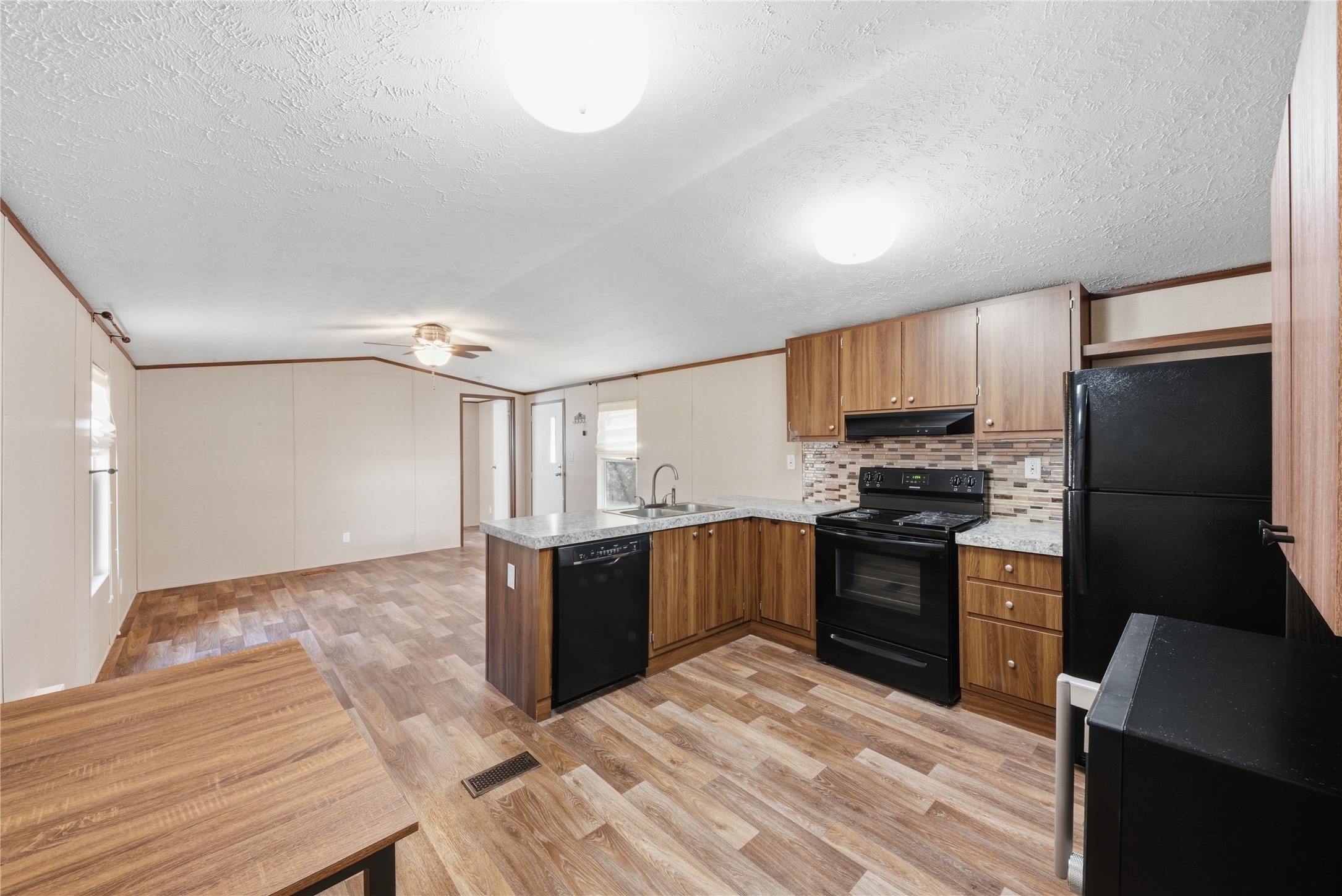 100 St Croix Drive Point Blank, TX 77364 - Photo 4 of 28 a kitchen with granite countertop a refrigerator stove top oven and sink