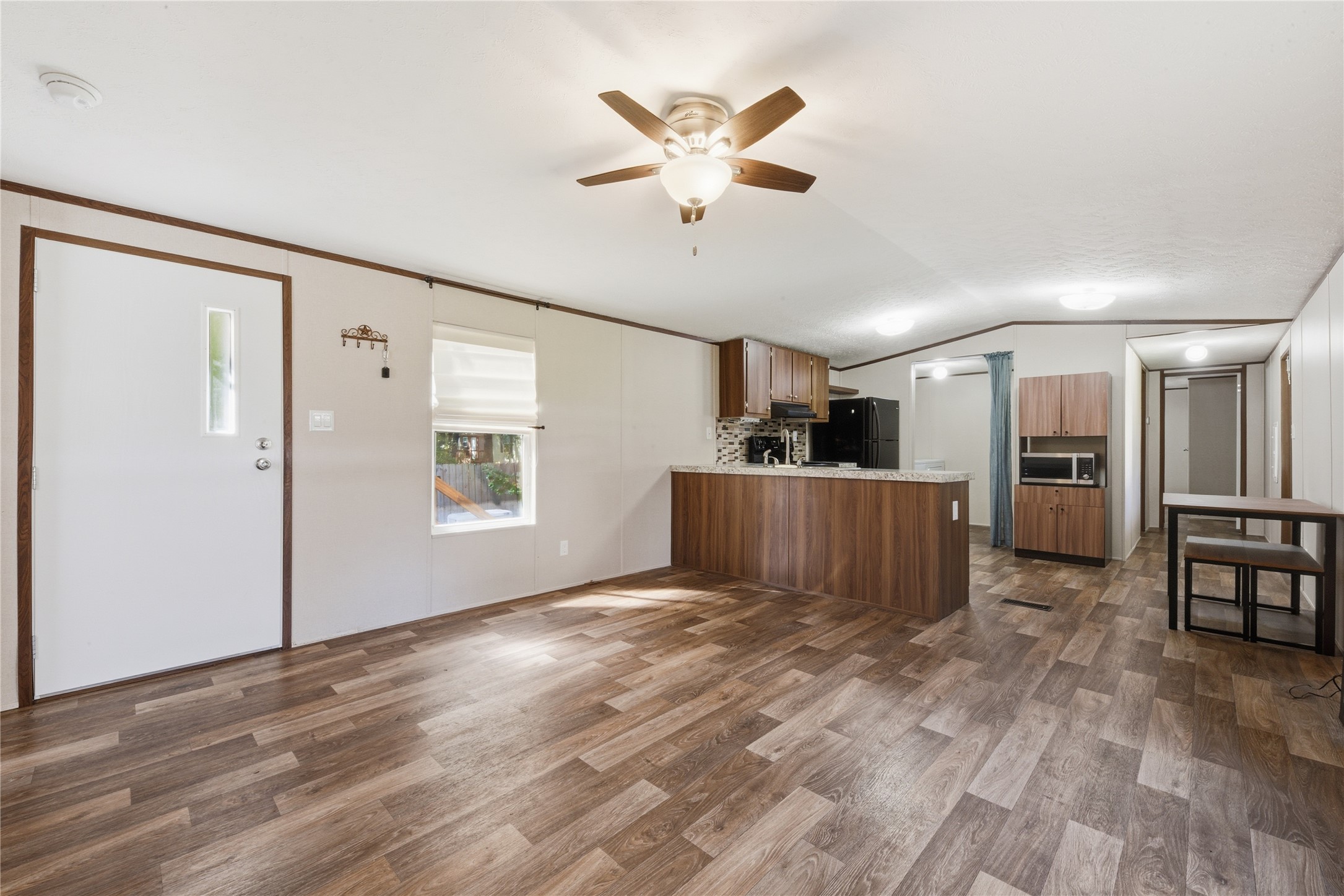100 St Croix Drive Point Blank, TX 77364 - Photo 5 of 28 a view of a kitchen with a sink and a refrigerator