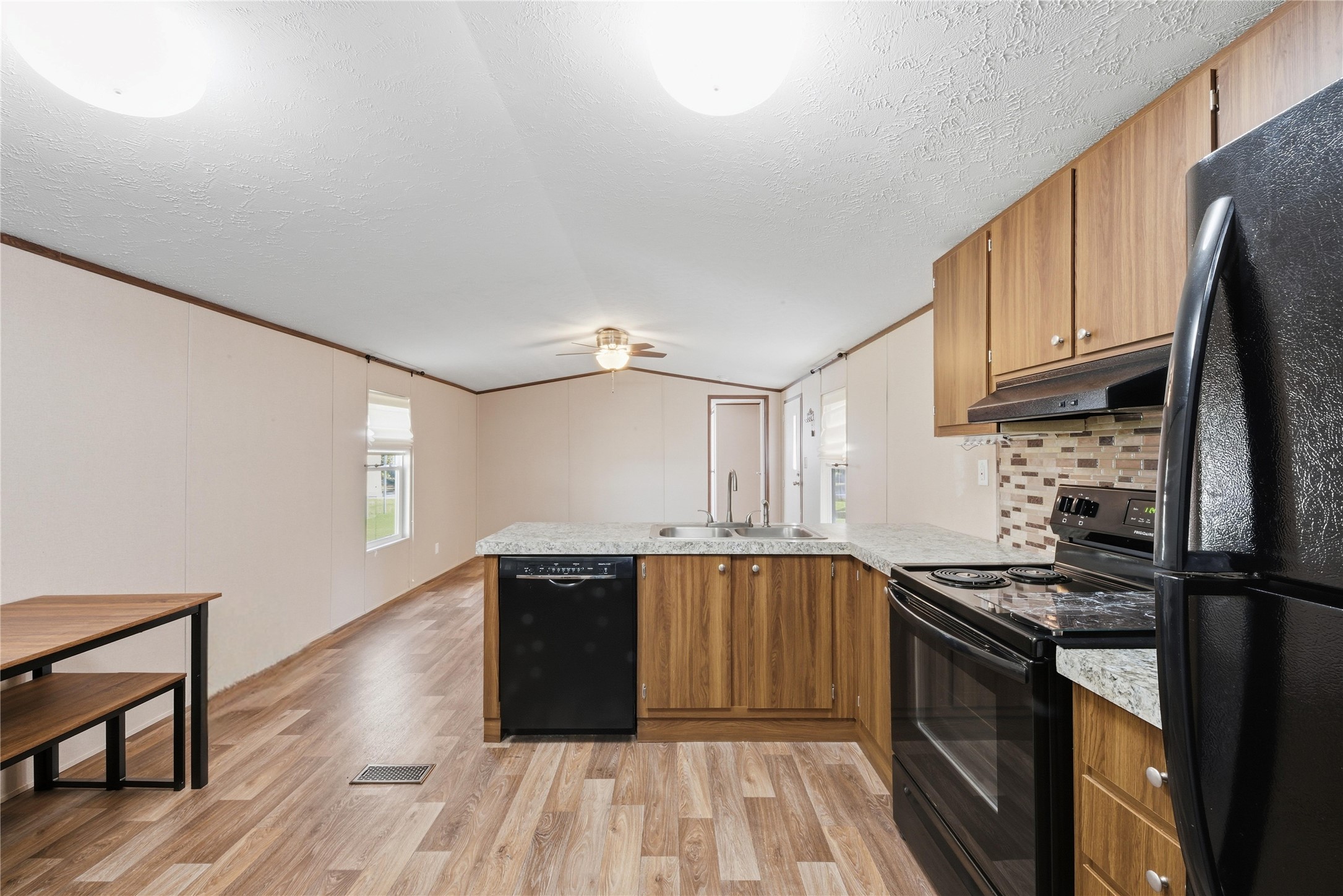 100 St Croix Drive Point Blank, TX 77364 - Photo 9 of 28 a kitchen with granite countertop a sink cabinets and stainless steel appliances