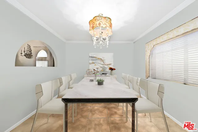 a view of a dining room with furniture and chandelier